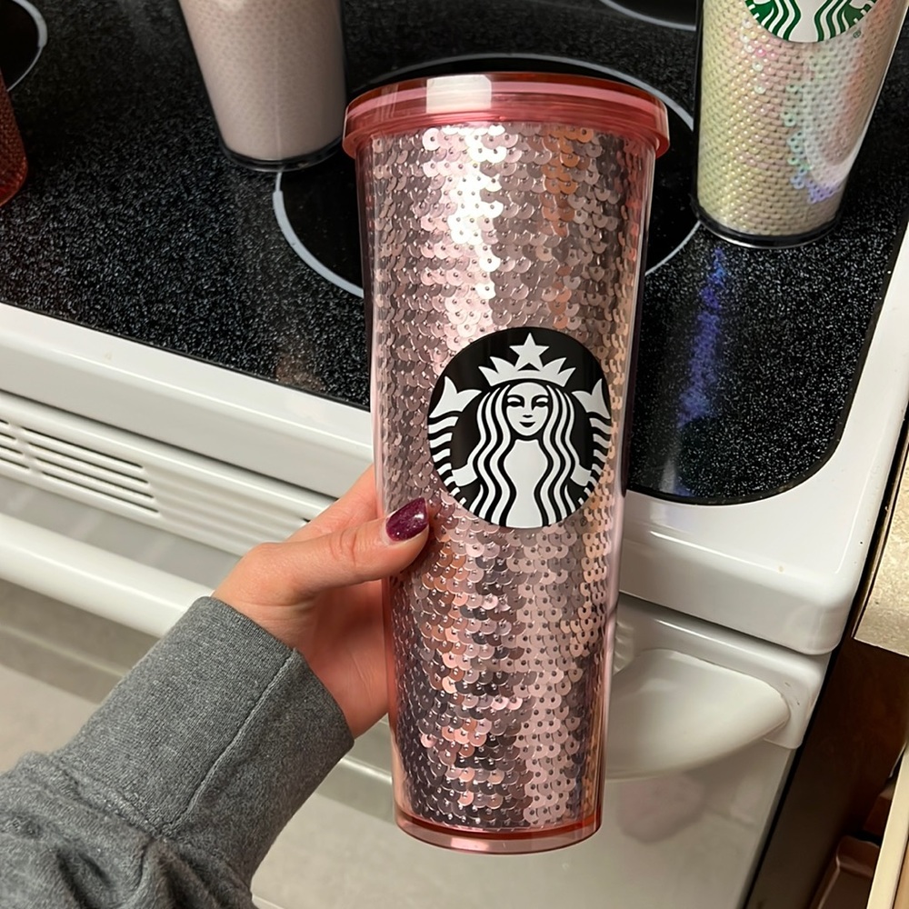 Pink Starbucks cup missing straw.